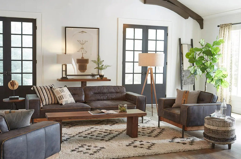 rustic home décor with leather sofa, leather arm chairs, natural fiber rug, side table and ample light coming through windows