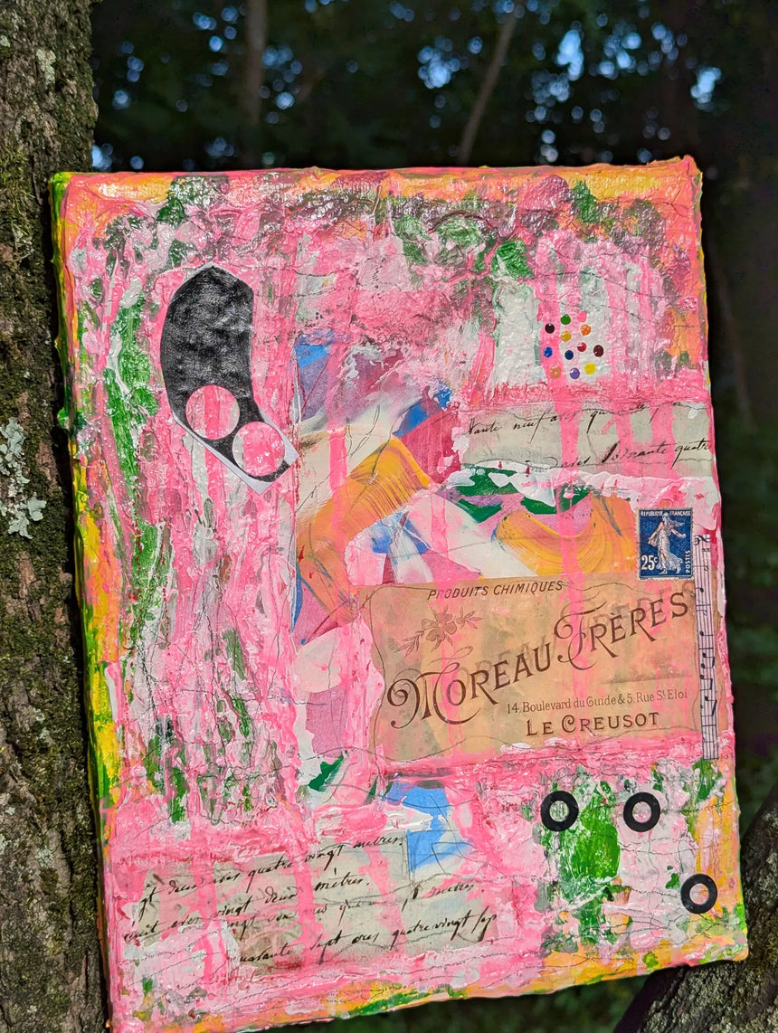 Colorful abstract pink heavy orginal art piece propped up on a tree