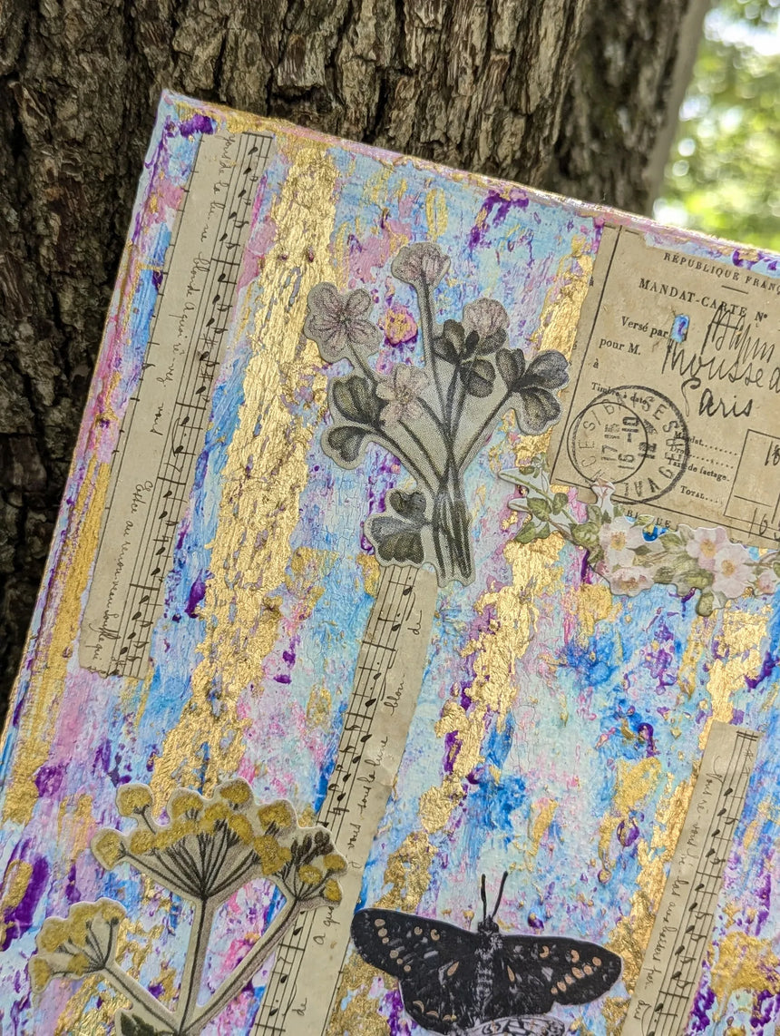 Top left corner close-up of mixed media canvas collage with floral, music and butterfly elements