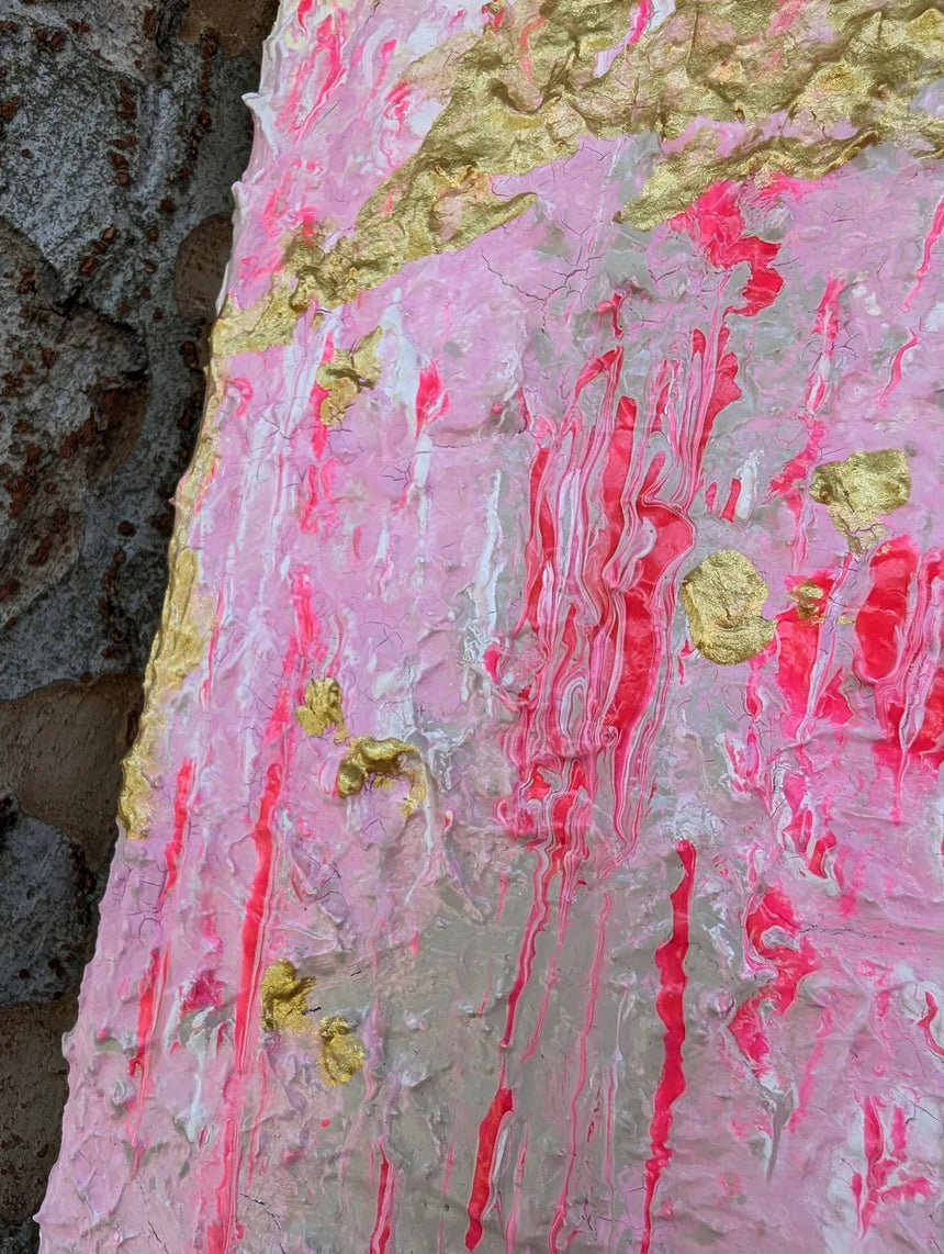 Close-up of a textured surface with pink and gold colors