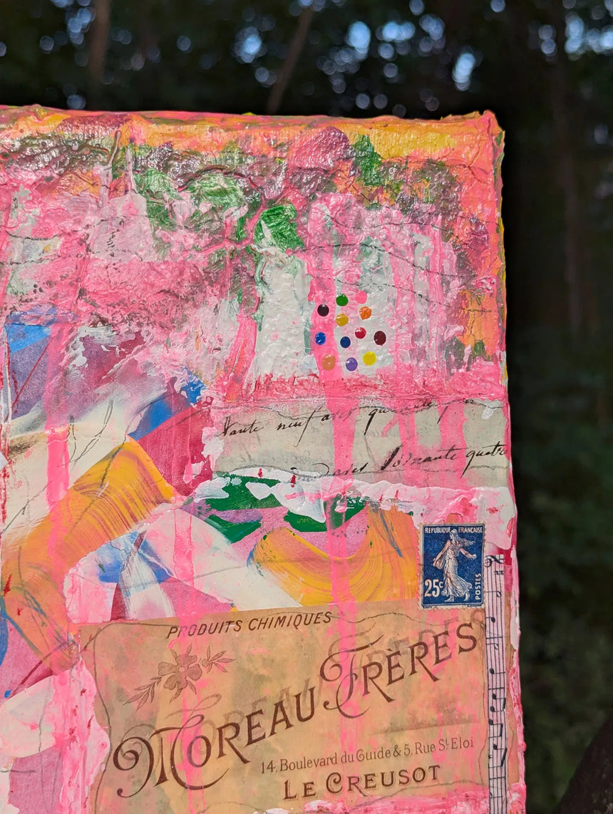 Colorful abstract painting leaning against a tree