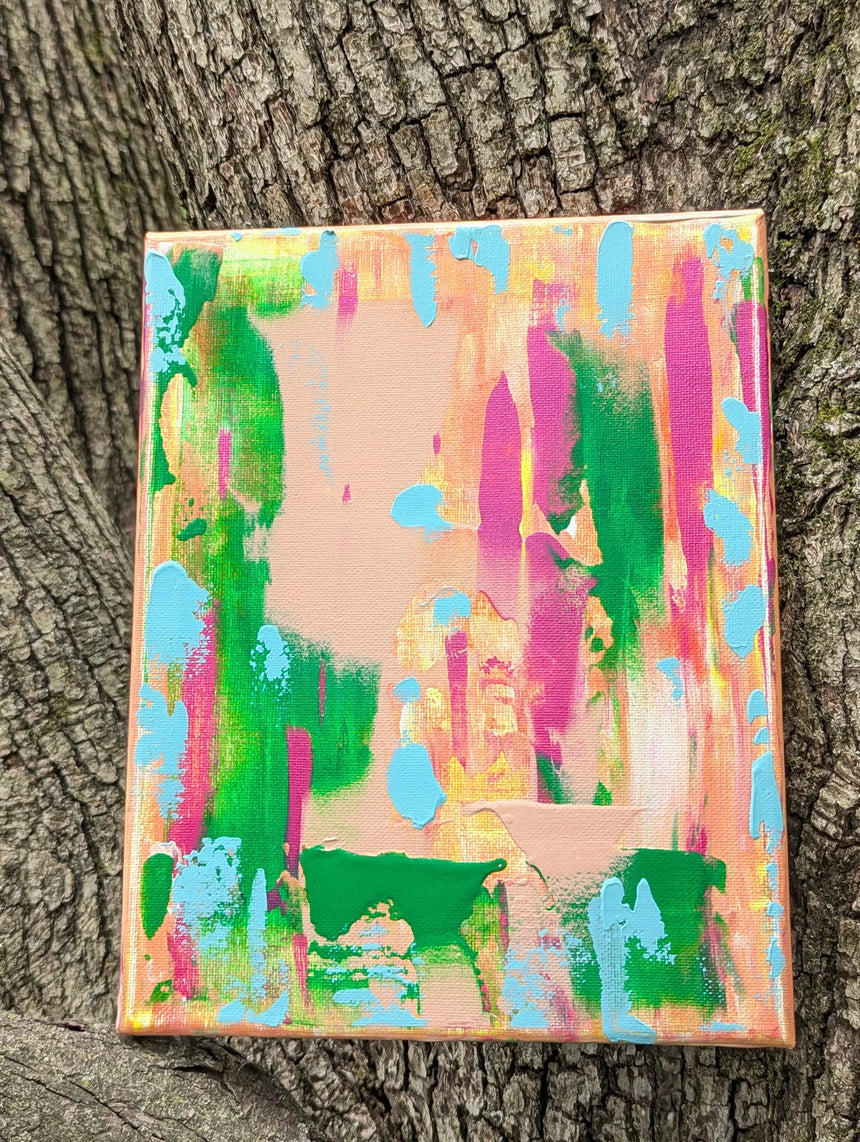 Colorful abstract painting against a tree trunk background in vivid colors