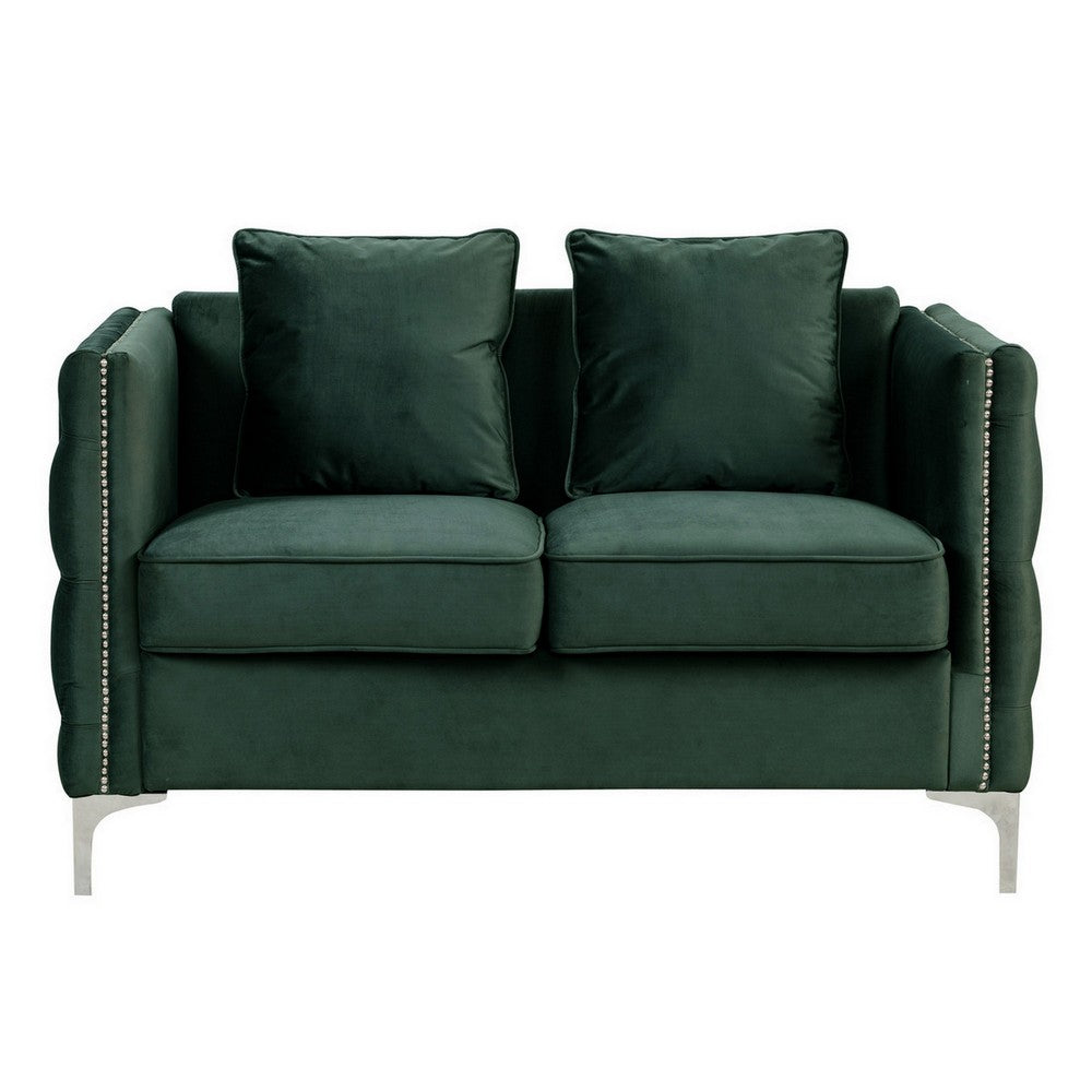 green velvet loveseat with two loose pillows