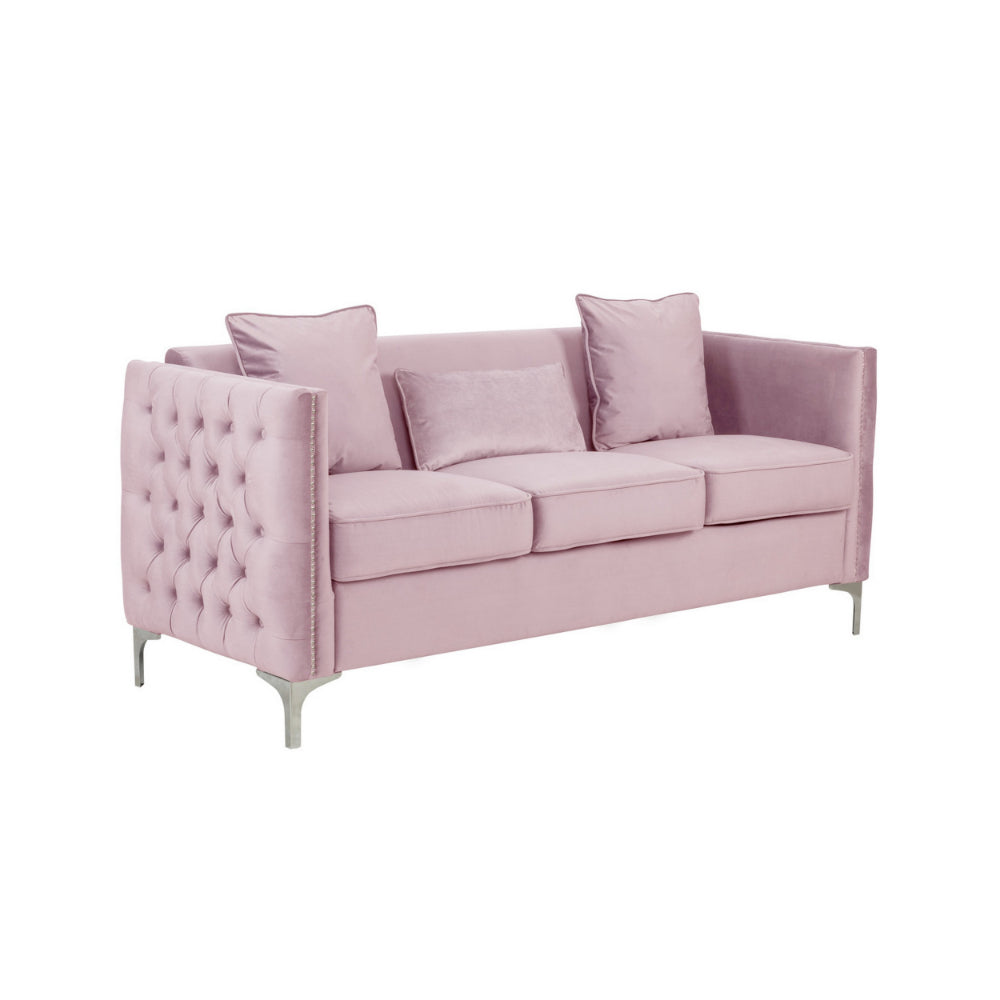 pink velvet sofa with three loose pillows