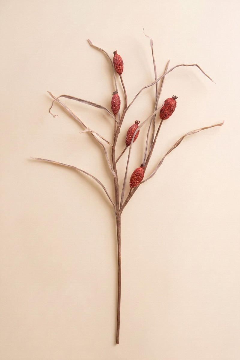 This tall faux botanical stem features slender branching lines accented with muted red berry-like details for an airy natural look.