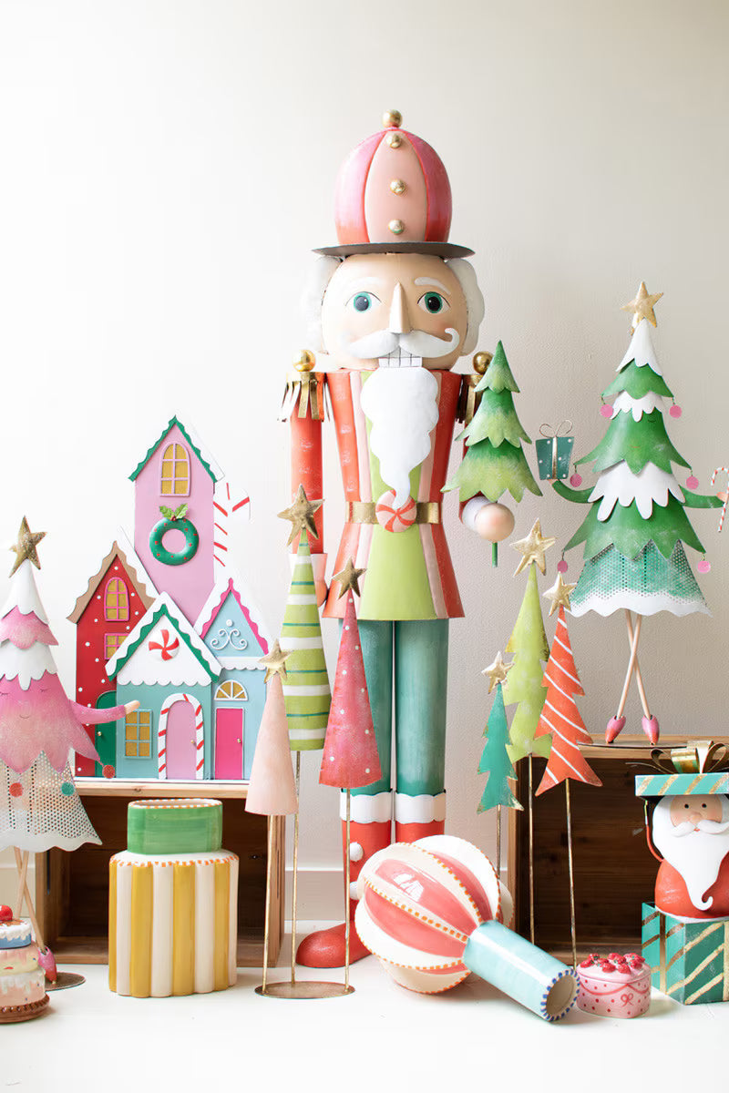 Decorative nutcracker with Christmas-themed items on a white background