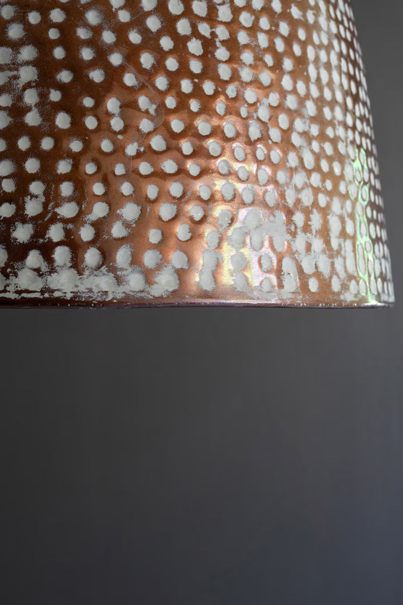 Close-up of a textured metallic surface with a dark background