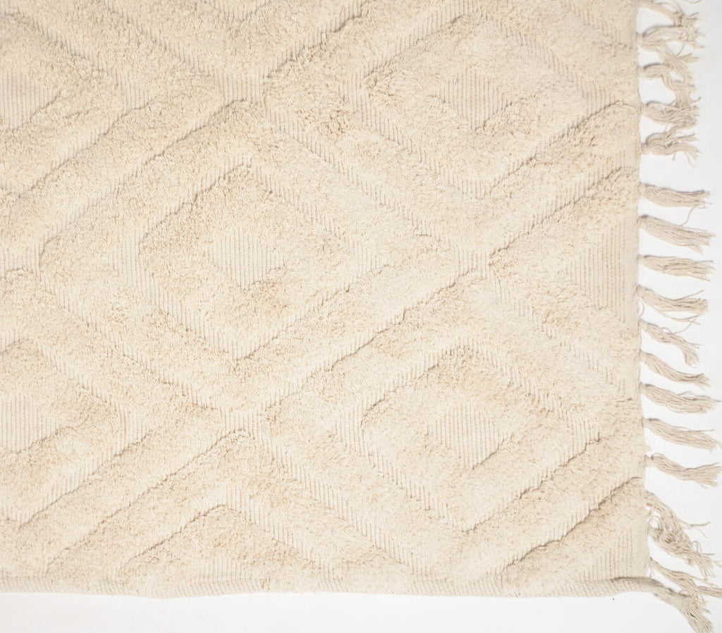 diamond patterned beige rug with tassels - close-up of weave pattern and tassels