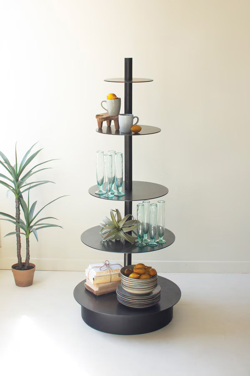 Black 5-tiered retail display shelf with decorative items on a white surface