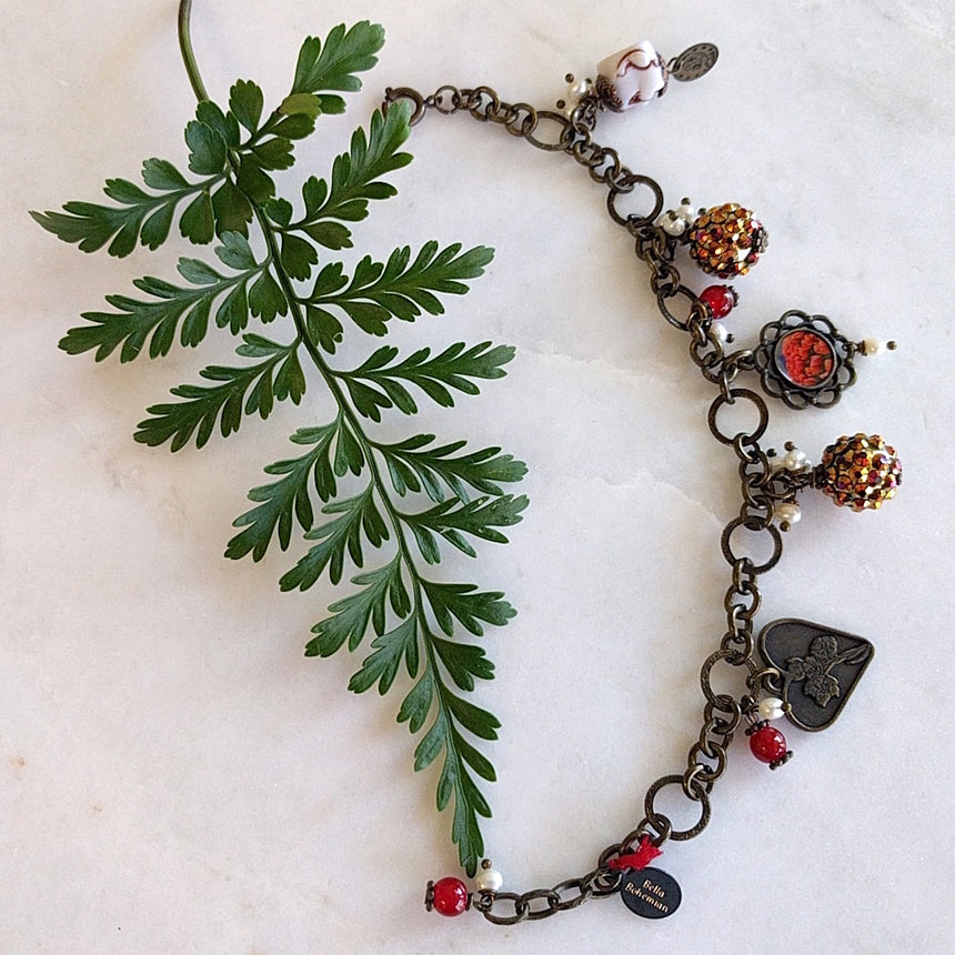 bracelet with charms including brass heart, red round glass, flower frame with red tulips image, round colorful balls and happy white buddha - different photo angle