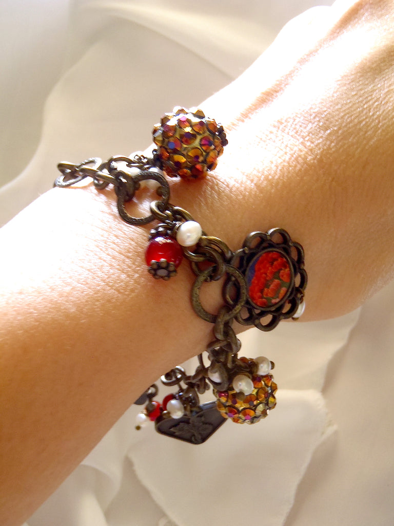 bracelet with charms including brass heart as seen worn on lady's wrist