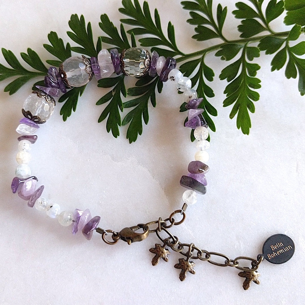 handmade bracelet using small irregular amethyst chips with translucent accent beads, medium round faceted glass beads on alternate background