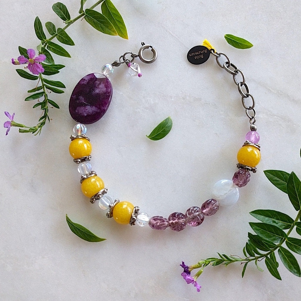 braclet with combination of yellow round jade, purple glass bead, clear Czech glass beads, a large faceted purple amethyst