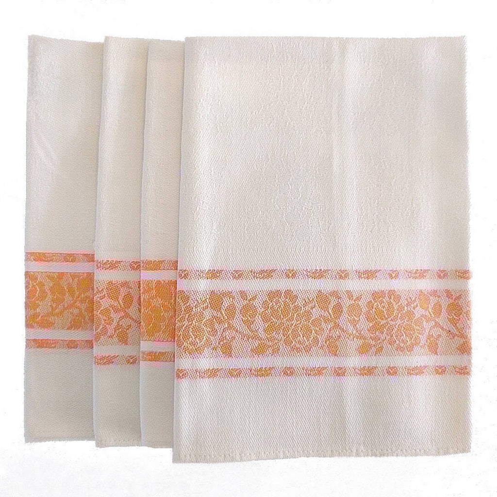 set of four white cotton napkins with orange detail and flower pattern