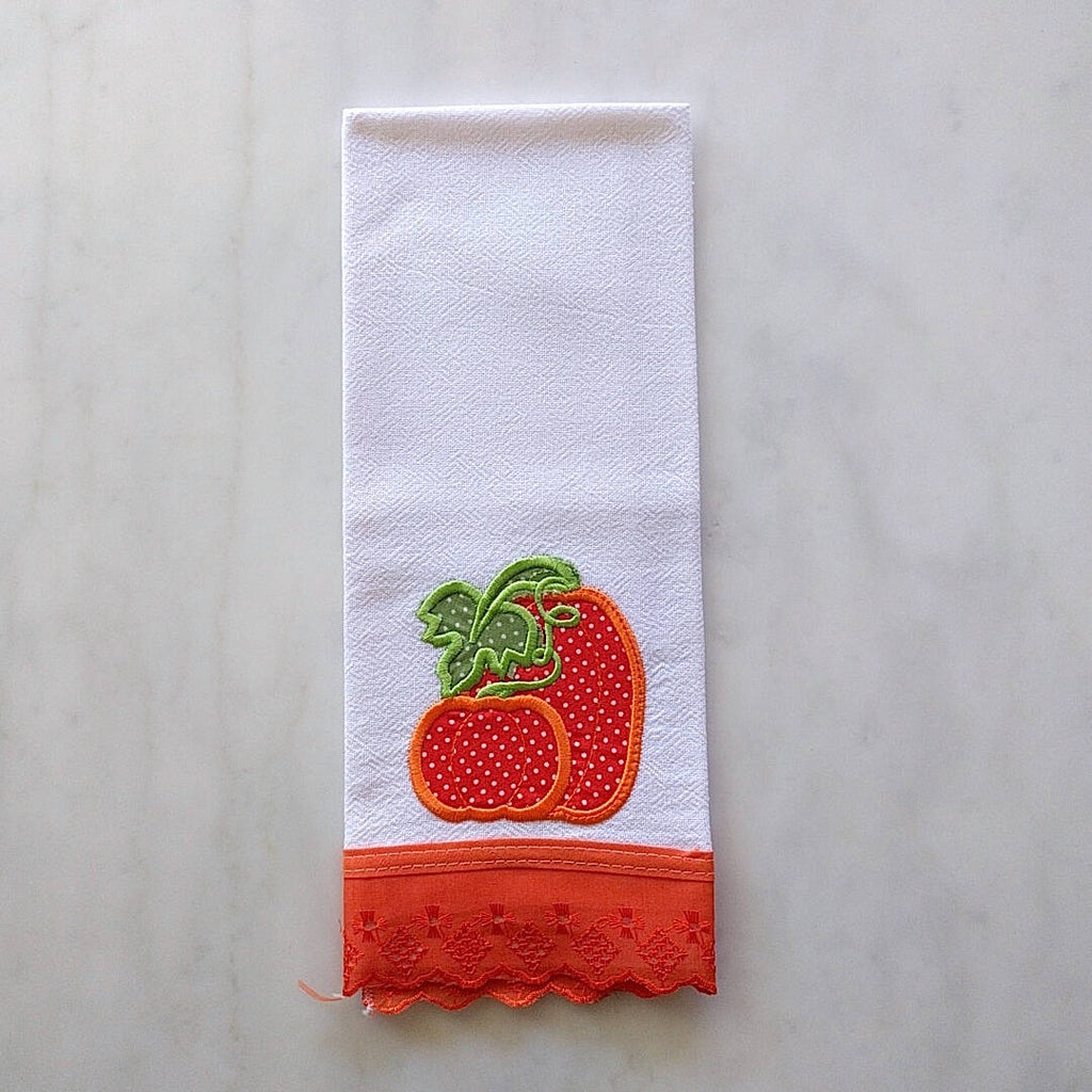 white tea towel with dark orange color strawberry machine embroidered and hemmed