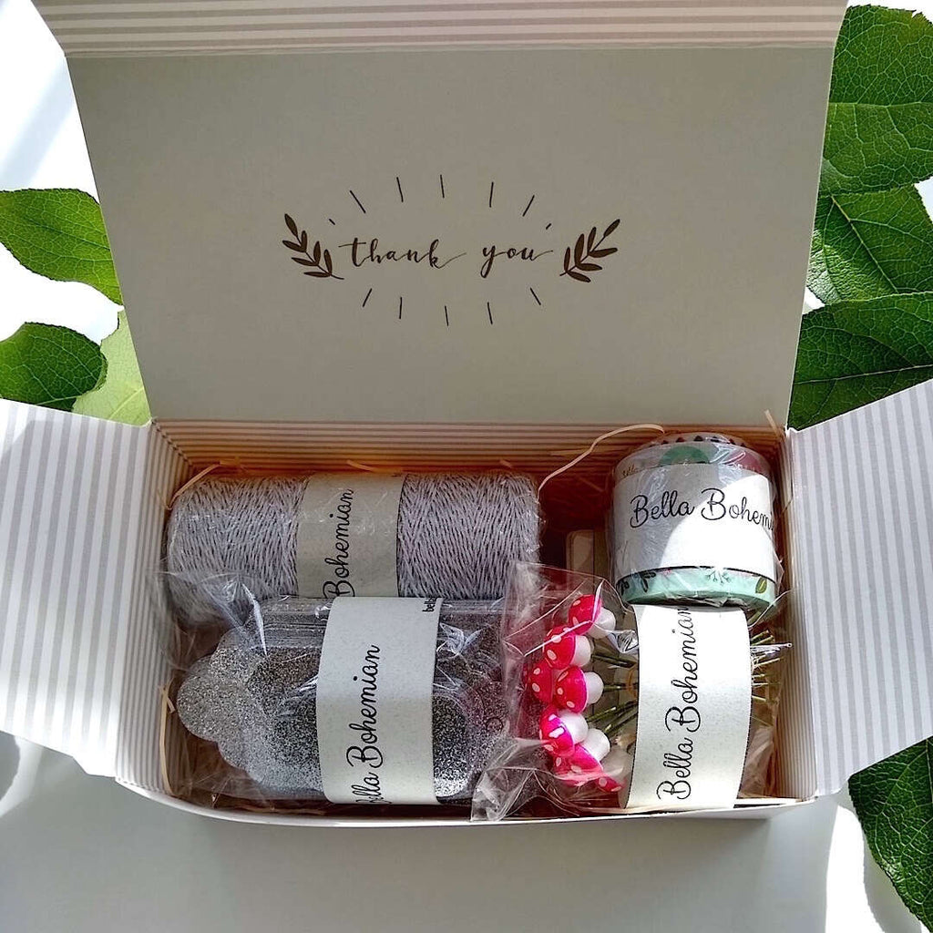 silver luxe glitter gift cards, white hang tags, German cotton spun mushrooms, metallic glitter bakers twine, plastic wrapped in gift box