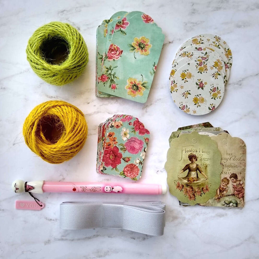 gift tags, hemp string, ribbon and Japanese pen laid out flat different arrangement