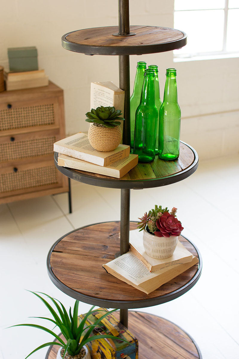 close up of round shelves with sample goods e.g. books and green bottles