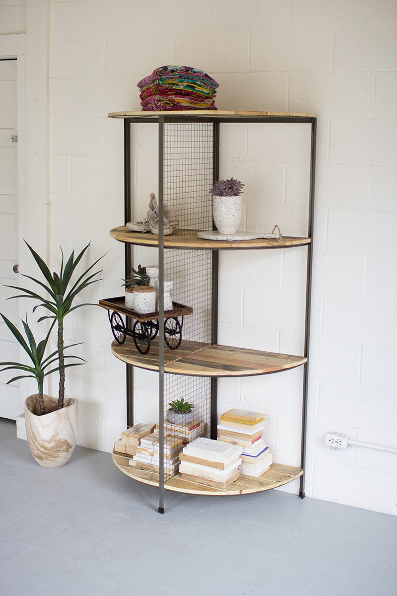 A semi-circular recycled wood and metal shelving unit with two tiers, mounted on a wall with various decorative items and plants on the shelves.