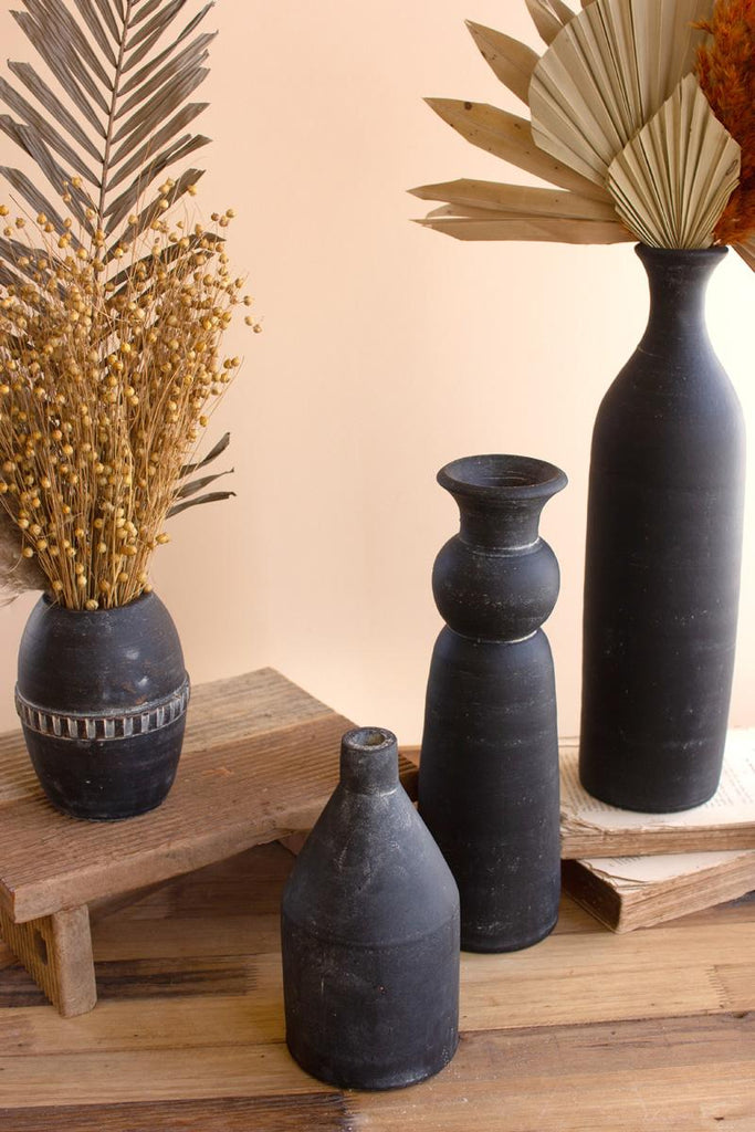 4 black clay vases of varying shapes & sizes - zoomed in - shown with dried plants