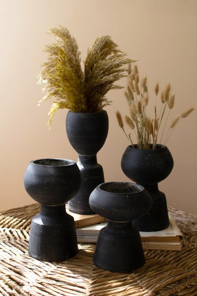 set of 4 black clay vases shown with reed plants