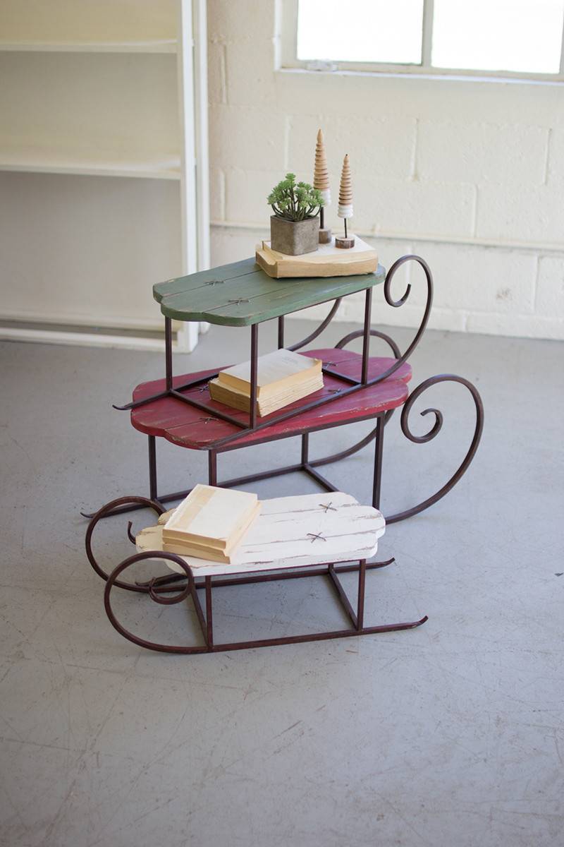 set of 3 painted wood and metal sleighs, in different colors: green, red and white