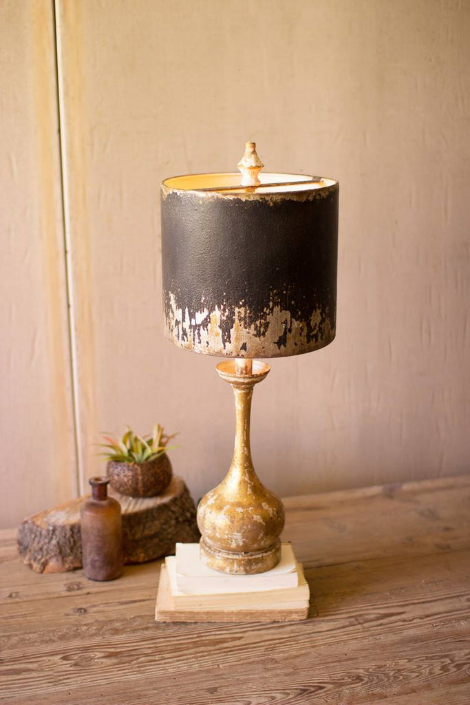 table lamp with round wooden base and black and gold shade