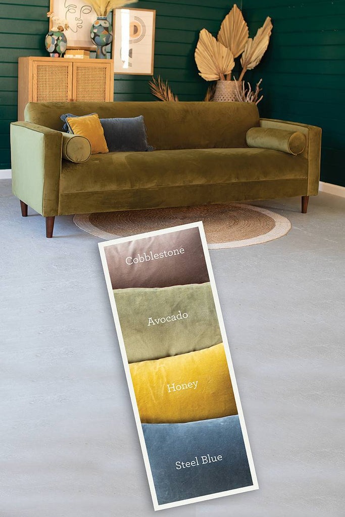 velvet sofa with two bolster pillows - also shows color swatch for cobblestone, avocado, honey and steel blue