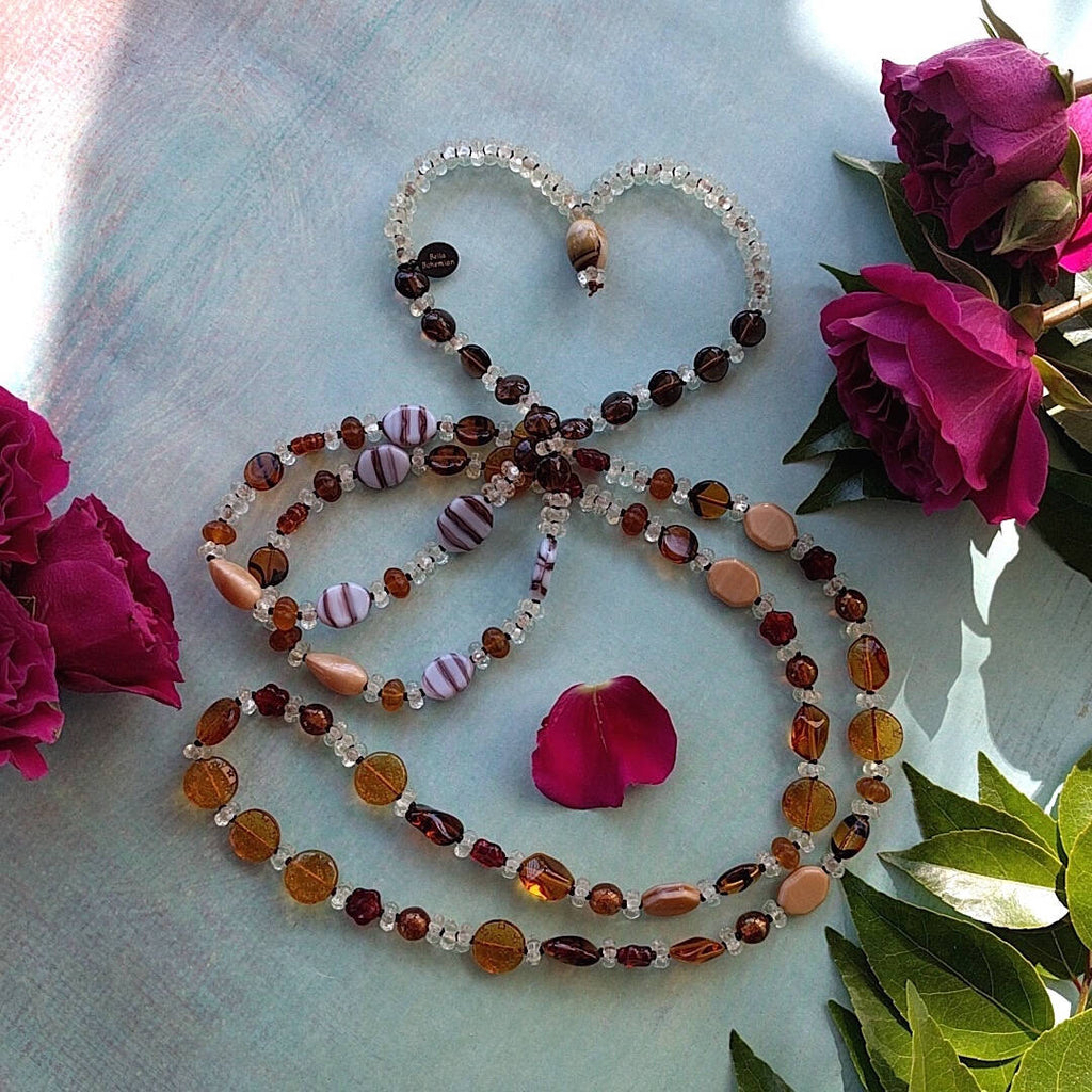 long necklace handmade with different sizes and shapes of multi-colored Austrian amber glass beads