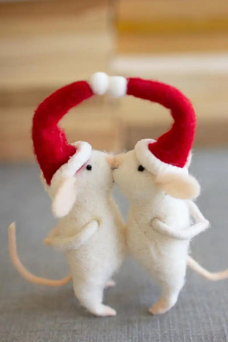 two white mice with red santa hats kissing in spirit of christmas