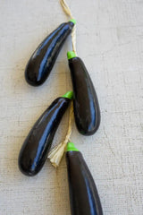 string of faux eggplants - close-up