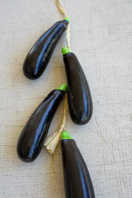 string of faux eggplants - close-up