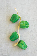 string of green faux bell peppers