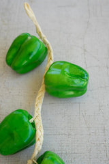 string of green faux bell peppers - close-up