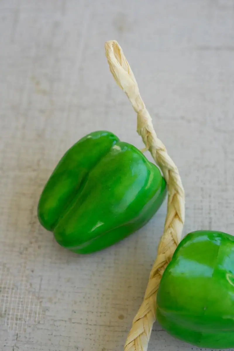 string of green faux bell peppers - close-up of one bell pepper