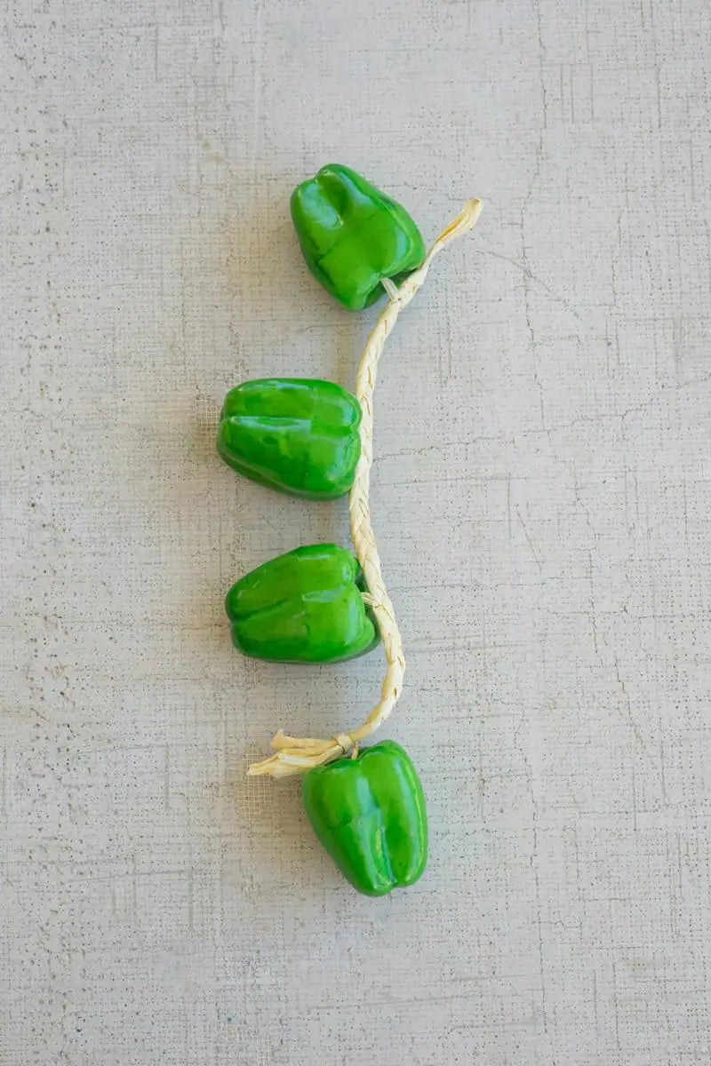 string of green faux bell peppers - lined up