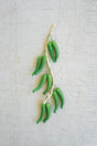 string of green faux peppers