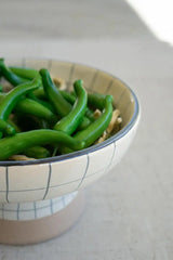 string of green faux peppers - close-up bowl shot