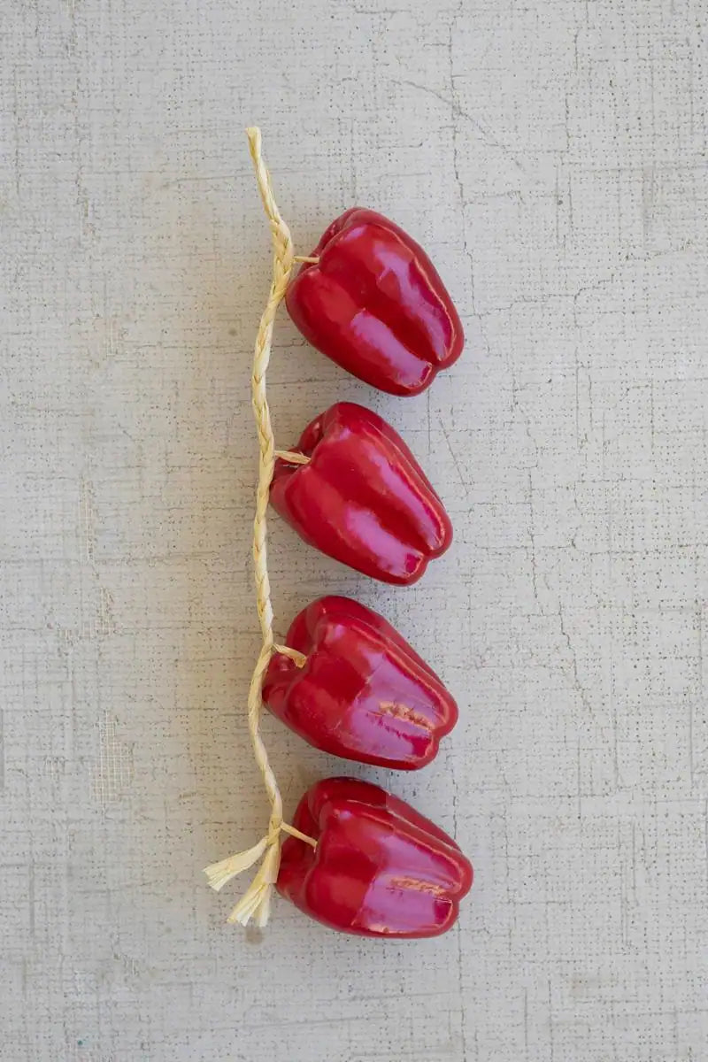 string of red faux bell peppers - lined up