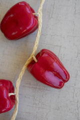 string of red faux bell peppers - close-up of one faux bell pepper