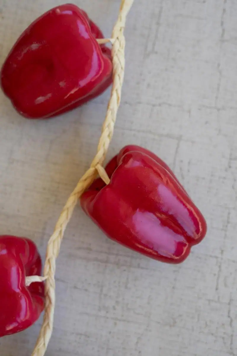 string of red faux bell peppers - close-up of one faux bell pepper