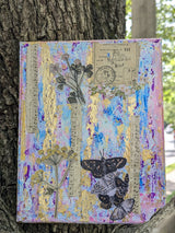Original decorative mixed media canvas collage with floral, music and butterfly design held by tree trunk