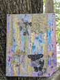 Original decorative mixed media canvas collage with floral, music and butterfly design held by tree trunk