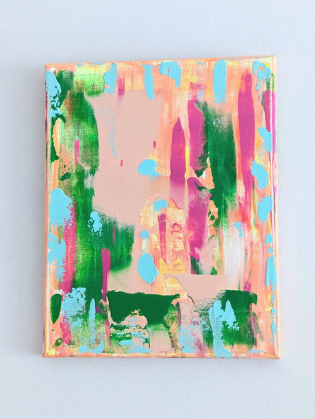 Colorful abstract painting on a light blue background shot inside home hence slight variation in color saturation