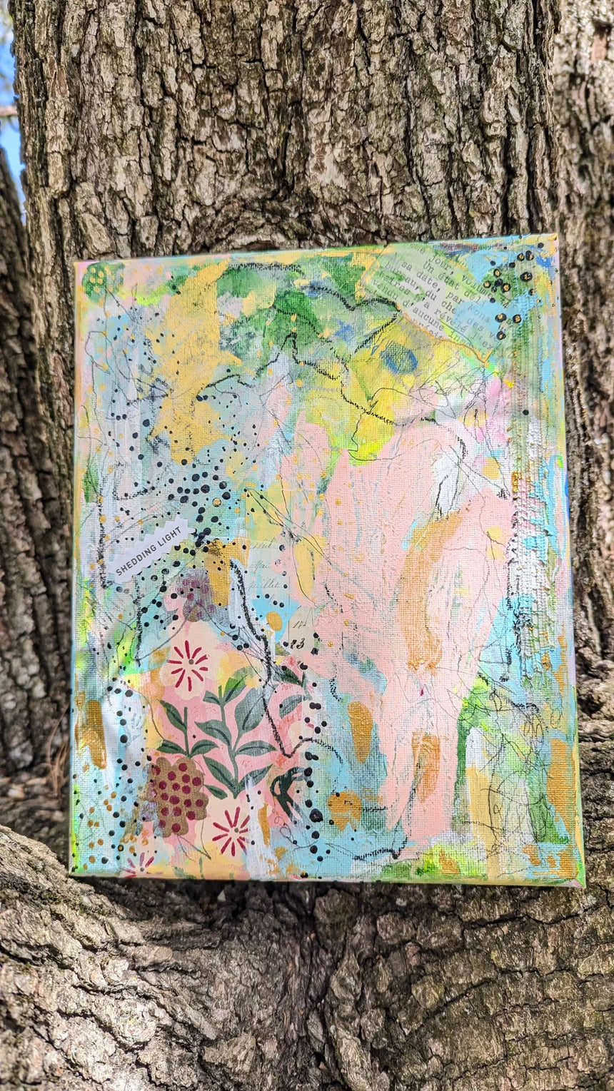 Colorful abstract painting on a textured surface against a tree bark background