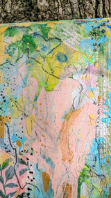 Abstract artwork with pastel colors and natural elements on a textured surface.