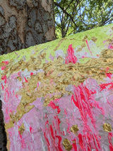 Original colorful abstract painting on a textured surface with a tree in the background - zoomed in on gold details