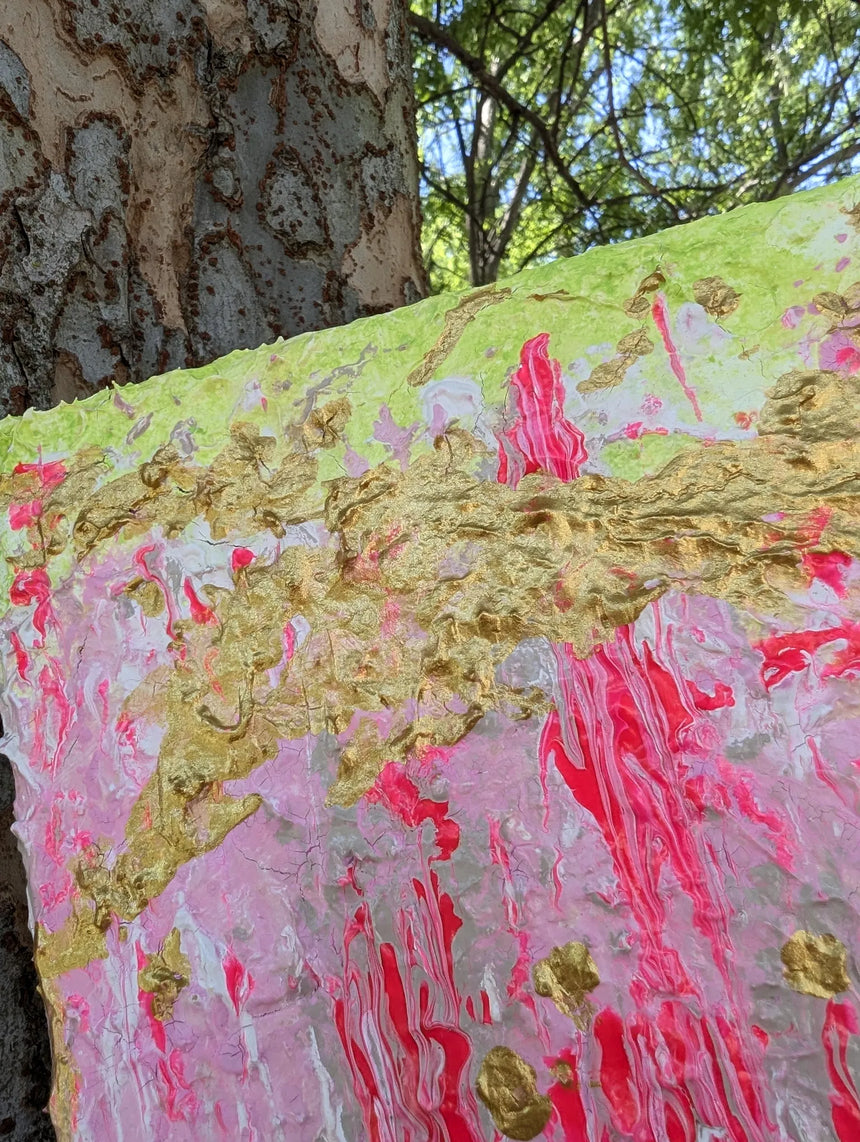 Original colorful abstract painting on a textured surface with a tree in the background - zoomed in on gold details