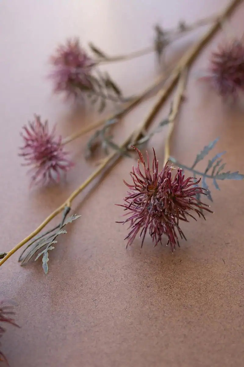 purple faux flower spray - focus on one blossom