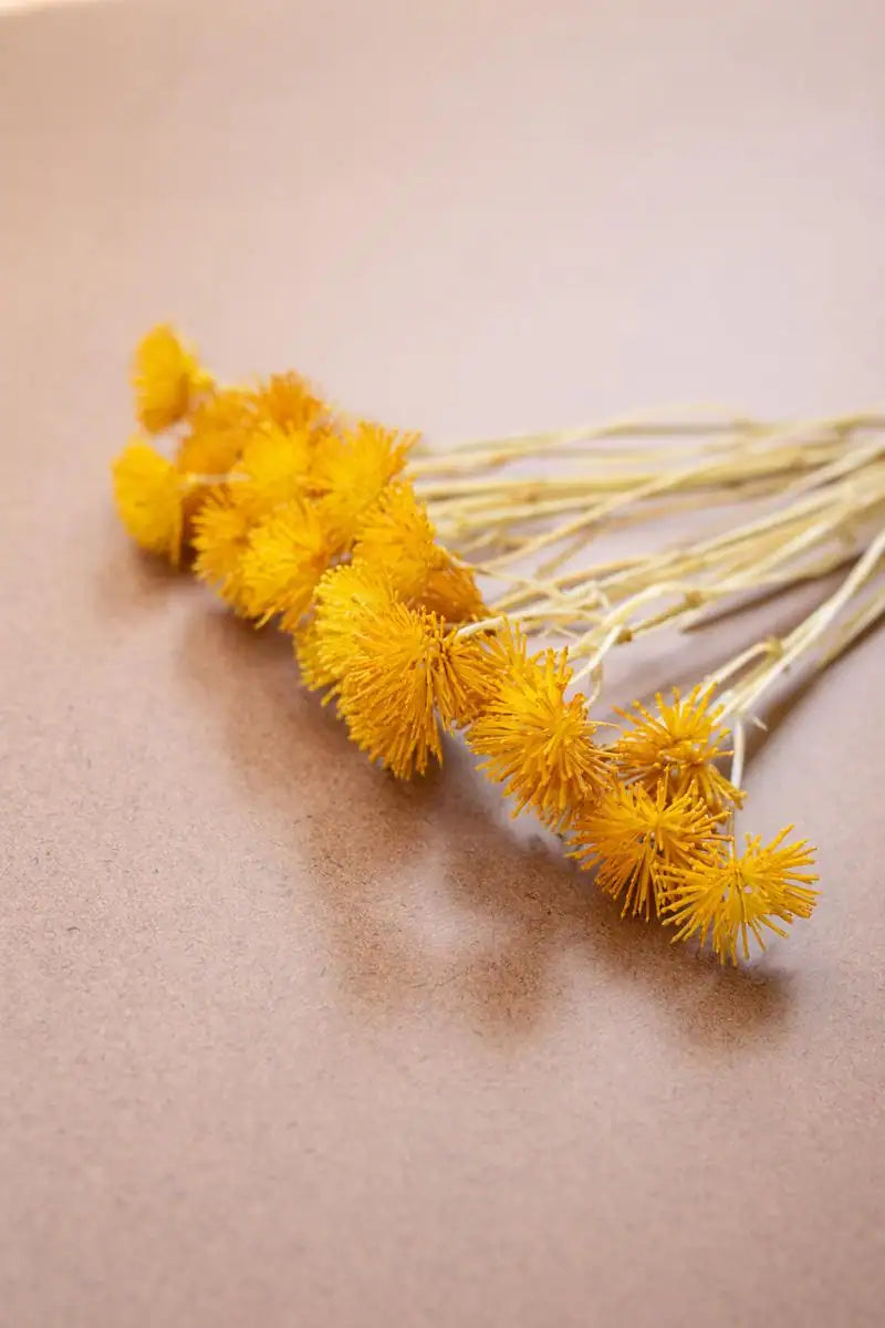 bundles of faux yellow mini flowers - angled close-up